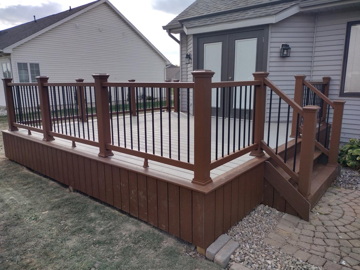 Custom composite deck with brown railings and aluminum balusters