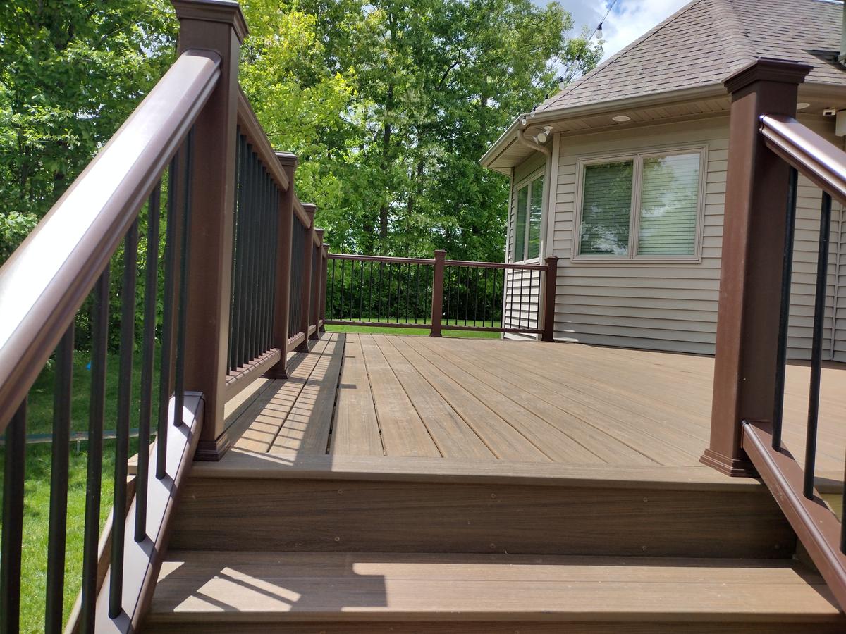 Composite deck with railings surrounded by trees