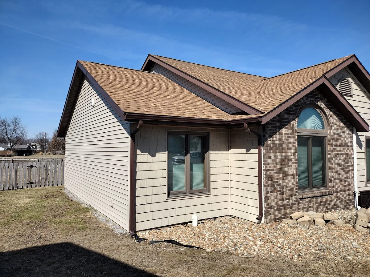Seamless gutter installation on residential home