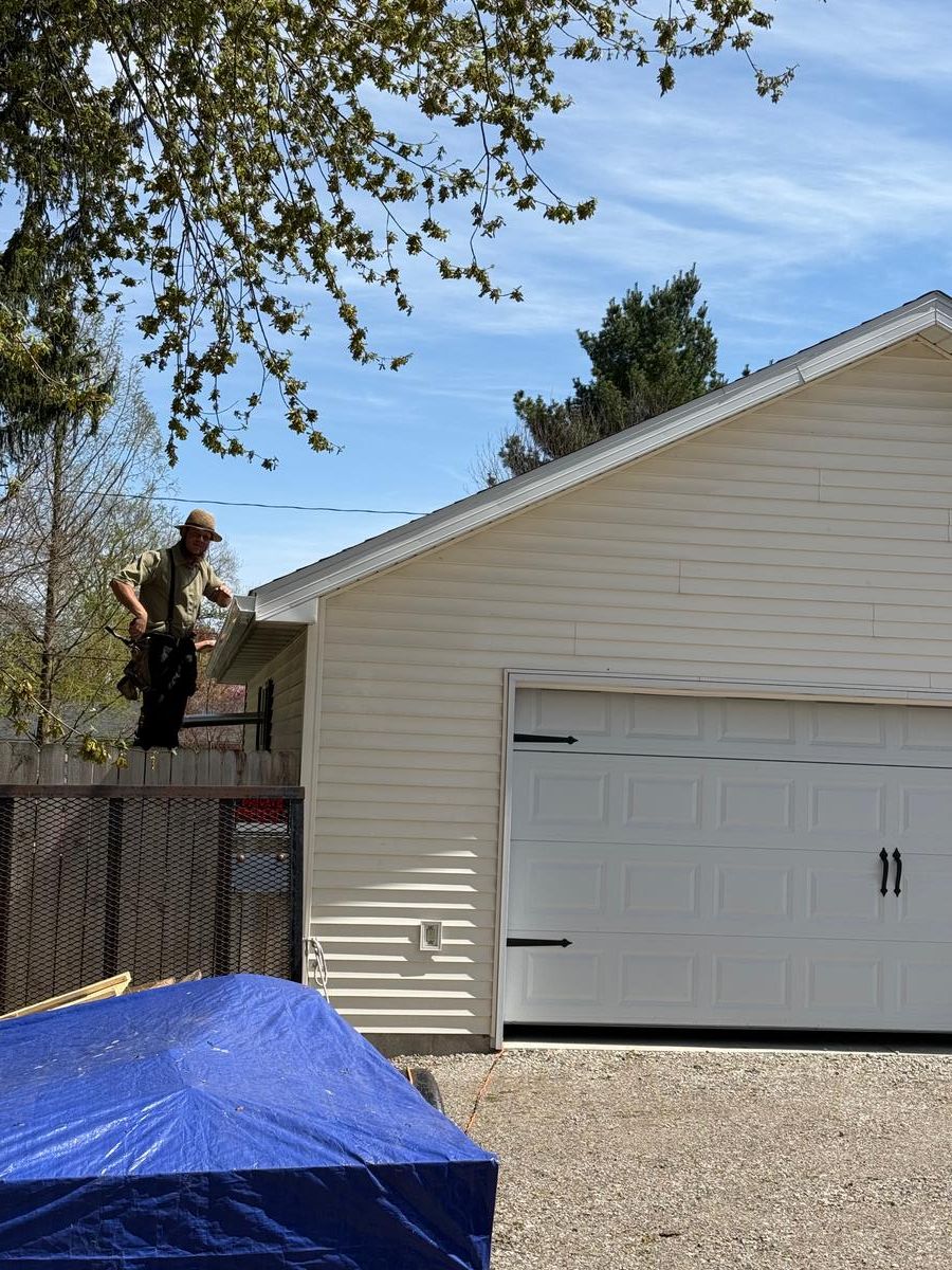 Crew at roofline installing gutter system