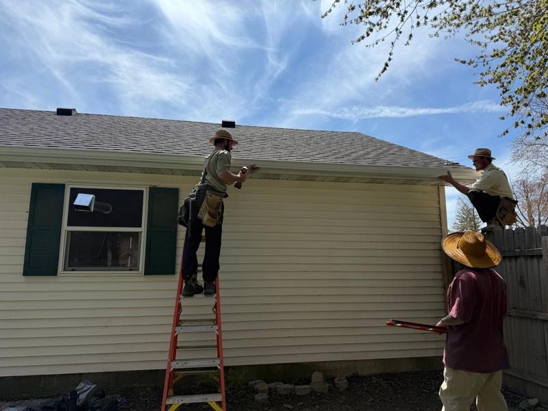J&N Quality Construction crew installing gutters on a job site